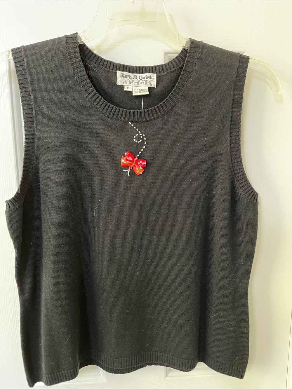 Black Sleeveless Sweater with Red Bow Accent